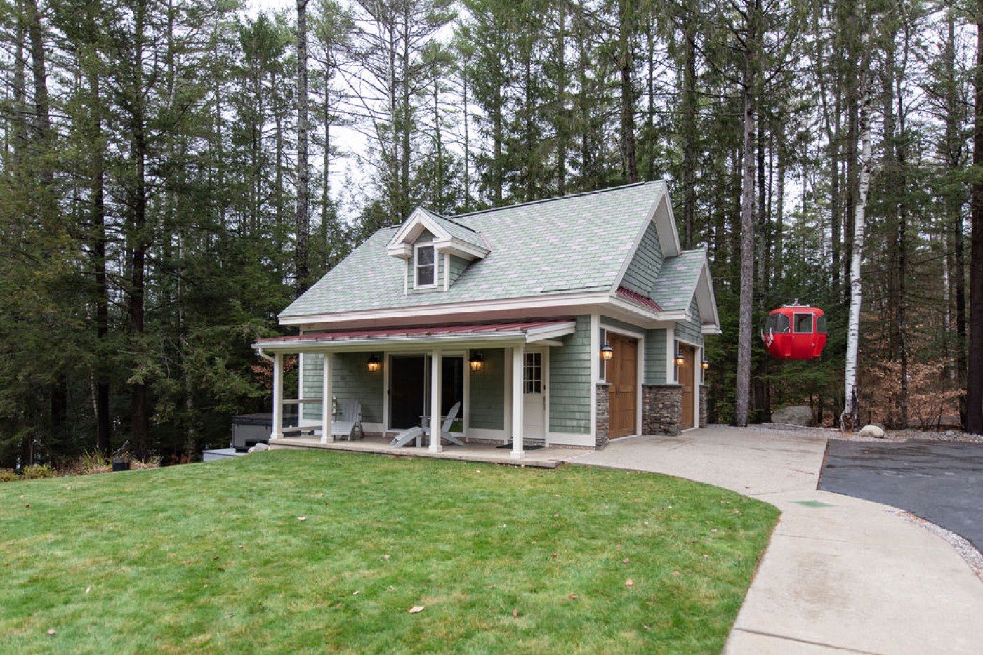 The sage-shingle guest house tucked into the pines at Camp Sunnyside, with a hot tub on the porch.